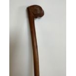 An adze carved hardwood early knob stick. Length 100cm.