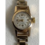 A ladies 18ct gold Mu Du Swiss made wristwatch on 9ct gold strap.