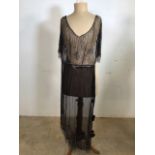 An early twentieth century - black tulle overdress heavily beaded to bodice and hem with beaded