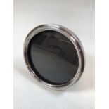 A silver photo frame - circular design. Hallmarked to edge Sheffield, J.R 1899 W:17cm x D:2cm x H: