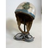 A MV Augsta motorcycle helmets on cast iron stand also with a a pair of motorcycle goggles.