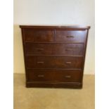 A large mahogany chest of drawers with two short over three long drawers with extra large base