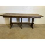 An oak serving table with three supports and carved details with pegs and stretcher bars. W:199cm