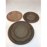 A pair of Eastern copper plates 28cm and one other 36cm