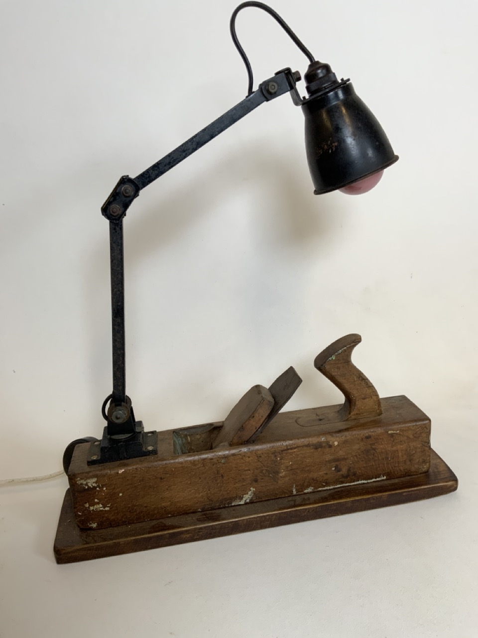 A Memlite adjustable metal lamp on converted plane base. W:49cm x D:13cm x H:58cm