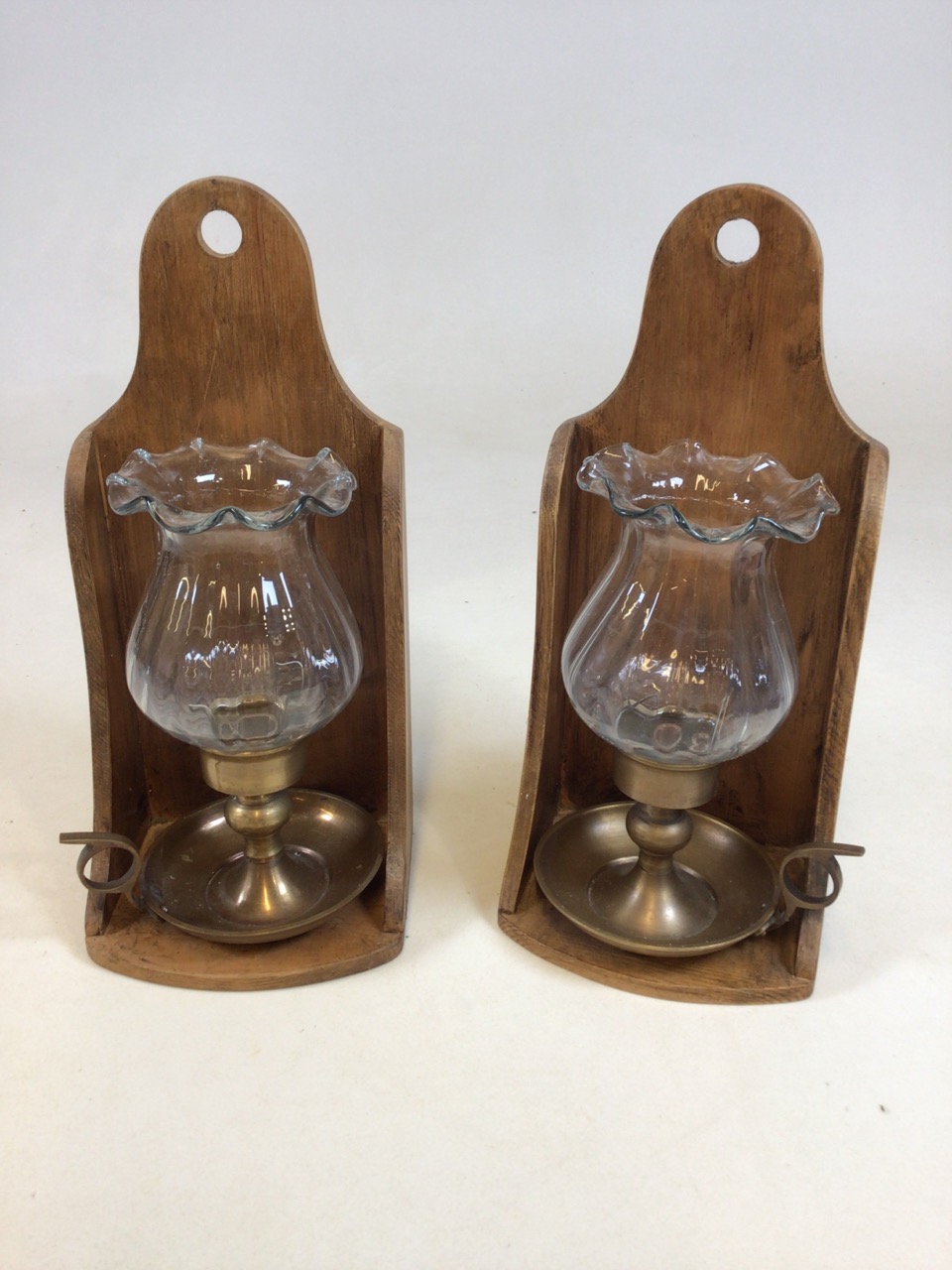 A pair of pine wall brackets with glass and brass candle holders W:16cm x H:35cm