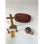 A vintage Frys tin containing a wooden travelling crucifix with candle sticks also with a Pusser rum