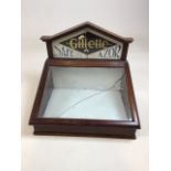 A vintage Gillette Safety Razor table top display cabinet, with hinged glass top printed with