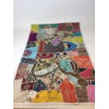 An embroidered, sequinned and beaded patchwork wall hanging W:92cm x H:150cm