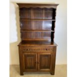 A small 20th century two piece country cottage oak dresser with two plate rack shelves, base with