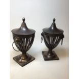 A pair of heavy brass ornamental lidded urns with lion head mounted handles W:23cm x H:43cm