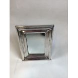 A white metal frame which can be adapted from a mirror to a photo frame. Hall marks worn and