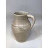 A glazed - undecorated Clarice Cliff Isis jug. Printed signature Clarice Cliff to base