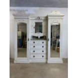 A Maple and co compactum wardrobe. Cream painted over mahogany bevelled mirrors with central chest