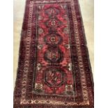 A geometric Baluchi rug with seven small detailed borders with five central medallions W:122cm x H: