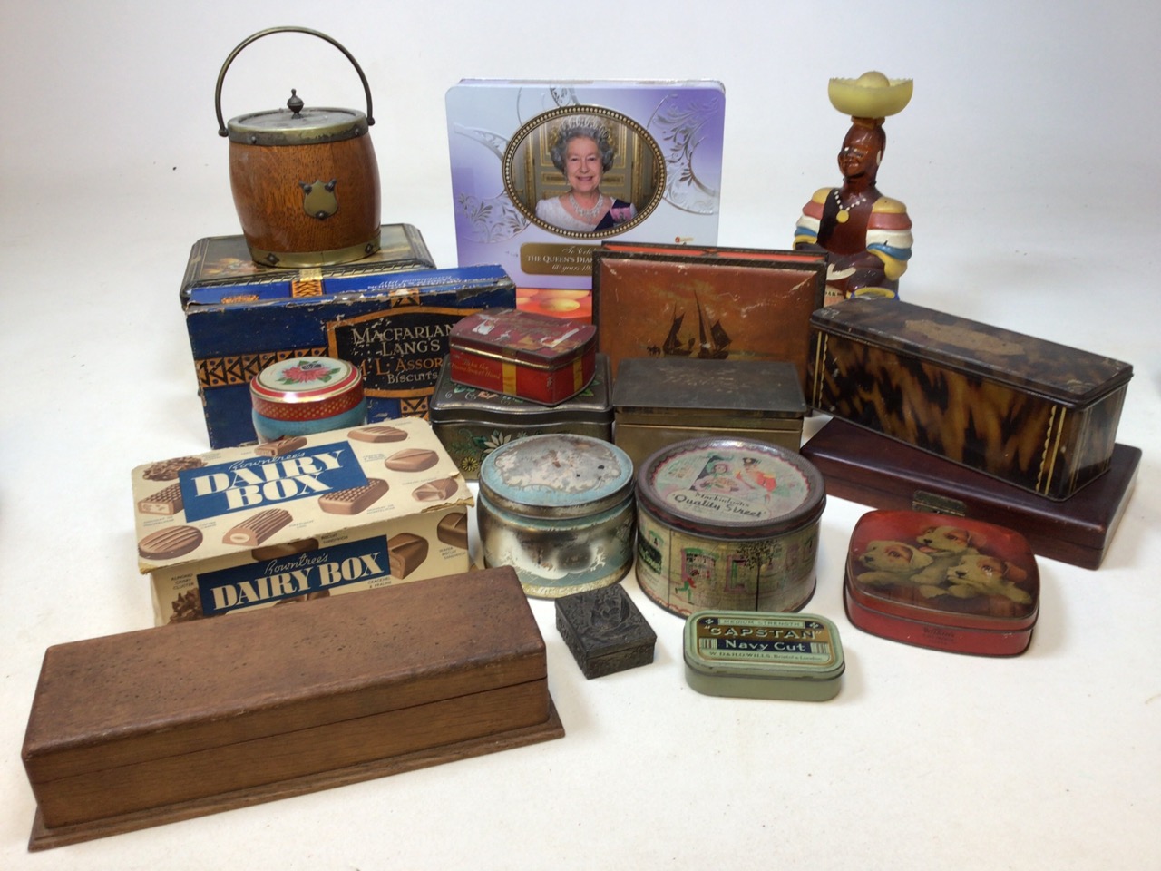 A quantity of vintage tins, some containing buttons, an old oak rum bottle and a biscuit barrel