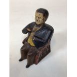 A Tammany cast iron money box, painted and modelled as a seated figure of a gentleman. Late 19th/