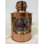A reproduction ships lantern, wired for electricity, with flickering candle effect. H:36cm
