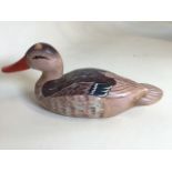A carved and painted decoy duck signed J Darie W:37cm x H:16cm