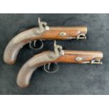 A pair of fine percussion travelling pistols by Clark of London. Browned Damascus barrels of 0.65