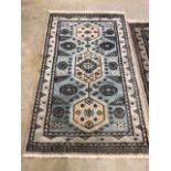 Two hand knotted wool rugs made in Pakistan W:97cm x H:170cm largest W:79cm x H:145cm