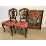 A pair of carved balloon back chairs upholstered chairs also with a fire screen.