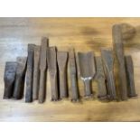 Thirteen masonry hand chisels. Largest H:33cm