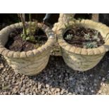 A pair of reconstituted stone circular planters. H:36cm