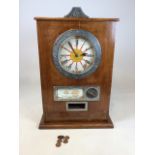 A Bryans Twentieth Century Twelve Win Clock Penny slot machine in a light oak case. When coin