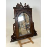 An early 20th century wall mirror with carved detail to top. W:65cm x H:76cm