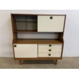 A mid century retro sideboard unit with glazed sliding doors and drop down cupboard. Sliding door to
