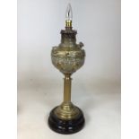 A brass oil lamp on ceramic base, converted to electric. Stamped The New Rochester made in the USA