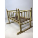A late nineteenth century / early twentieth century rocking dolls crib W:47cm x D:60cm x H:48cm