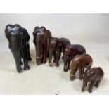 A set of 6 ebony elephants. height of tallest 26cm.largest has no tusks - smallest has tusks in