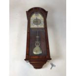 A 20th century Comitti of London Triple chime, 8 day movement wall clock with glazed front and sides
