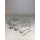 A quantity of etched glasses also with 11 water glasses and a pair of glass servers