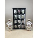 A collection of Japanese china cups on miniature shelves also with a pair of continental vases.
