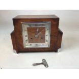 An oak Art Deco mantle clock with key. Small label to back marked CWS ltd clock case factory London.
