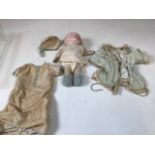 An Armand Marseille doll. A/F Damage to hands and eyes need attention. H:18cm