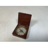 A nineteenth century mahogany cased pocket compass with paper dial and blue compass needle. No front
