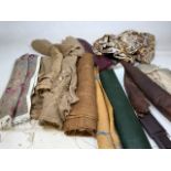 A bundle of upholstery fabrics including leather, vinyl, hessian, cushion covers, a tapestry seat