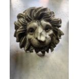A Cast reconstituted stone lion head wall decoration. Approx W:28cm x H:28cm