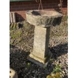 A three piece reconstituted stone bird bath on square tiered base. H:65cm