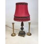 A black marble and gilt table lamp with red fringed shade together with a pair of candlesticks W: