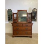 An art nouveau dressing chest, with bevelled mirrors, period handles and carved spindles. W:122cm