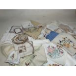 A quantity of embroidered table linen, includes table cloths, napkins, tray cloth, place mats and