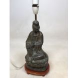 A bronzed metal buddah converted to a table lamp. Base sits on wooden plinth H:30cm to top of head