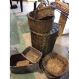 A quantity of vintage baskets including a laundry basket, a shopping basket and others