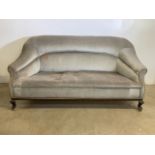 An early 20th century velour sofa on brass castors. W:180cm x D:85cm x H:90cm
