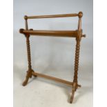 A bobbin twist light wood towel rail. W:75cm x D:24cm x H:87cm